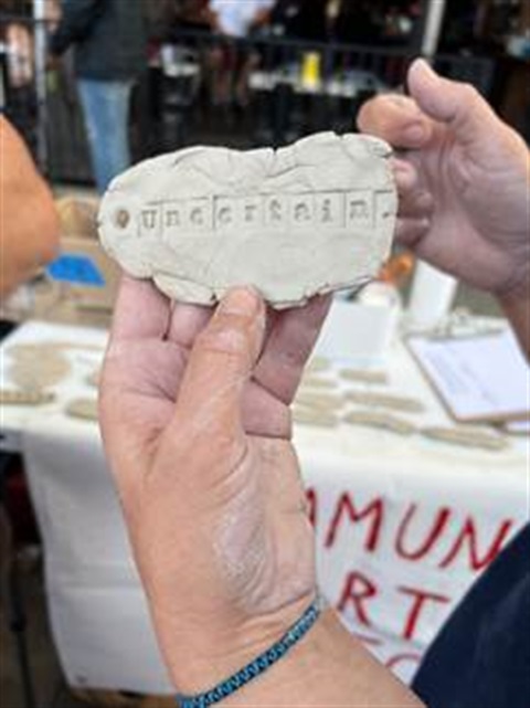 Hands holding ceramic tile